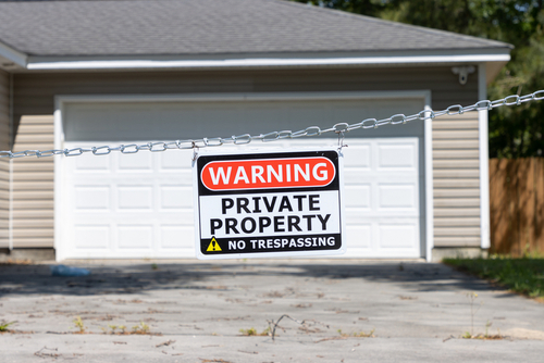 A,Private,Property,No,Trespassing,Sign,Hangs,From,A,Chain