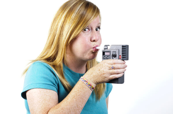 Woman Blowing Into A Police Breath Testing.